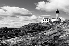 Beavertail Lighthouse Over Jagged Rocks Outside of Newport